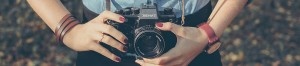 Woman artist with SLR camera.